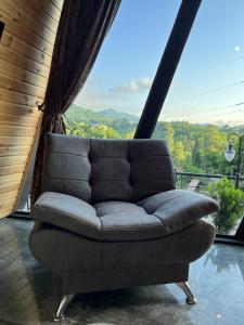 a couch sitting on a balcony with a view at Barbare Cottage in Chakvi