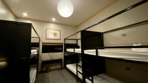 a room with three bunk beds and a light at Lavung Village in Ða Gia