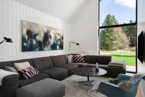 a living room with a couch and a table at 1385-Bedsted-Thy-Nedergardsvej-5 in Istrup