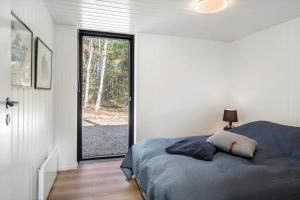 a bedroom with a bed and a large window at 1385-Bedsted-Thy-Nedergardsvej-5 in Istrup