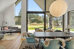 a living room with a table and chairs at 1385-Bedsted-Thy-Nedergardsvej-5 in Istrup