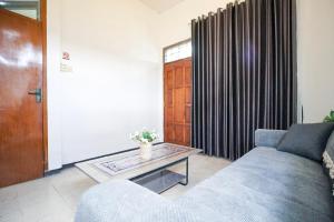 a living room with a couch and a table at Omah Alamanda in Sleman