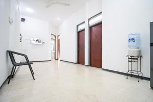 a empty room with a chair and a door at Omah Alamanda in Sleman