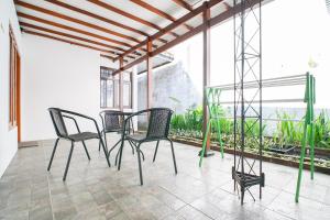 a group of chairs sitting on a patio at Omah Alamanda in Sleman