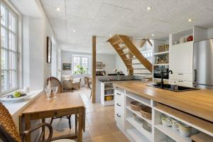 a kitchen with white cabinets and a wooden counter at 4263-Stege-Mollebrondstraede-13 in Stege