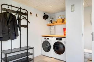 a laundry room with a washer and dryer at 4263-Stege-Mollebrondstraede-13 in Stege
