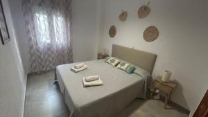 a bedroom with a bed with towels on it at Toque Andaluz Zarzas in Muntanya la Sella +29 photos