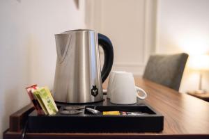 a coffeemaker sitting on a table next to a mug at De Zwaan Delden in Delden