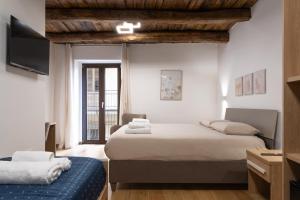a hotel room with two beds and a tv at Torre 47 - 49 Rooms in Lamezia Terme