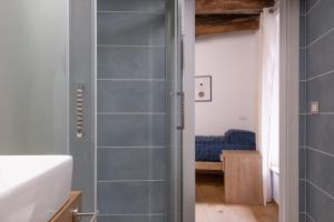 a bathroom with a shower with blue tiles at Torre 47 - 49 Rooms in Lamezia Terme