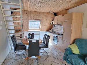 a small kitchen and dining room with a table and chairs at Hof Junkernberg in Bispingen