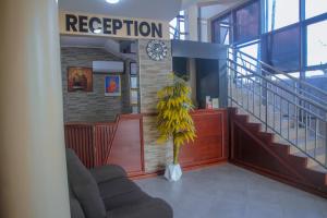a lobby with a waiting room with a plant at Andrew View Hotel in Dar es Salaam