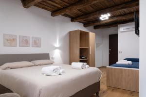 a bedroom with a large bed with towels on it at Torre 47 - 49 Rooms in Lamezia Terme +35 photos