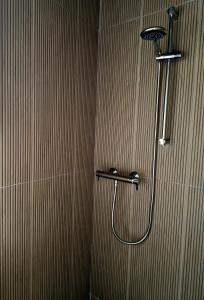 a shower with a shower head in a bathroom at The old B&B in Killucan +23 photos