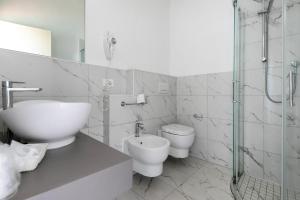 a bathroom with a sink and a toilet and a shower at Hotel Simon in Gatteo a Mare +18 photos