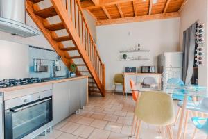 a kitchen and dining room with a glass table at La Tour de La Palme in Lapalme