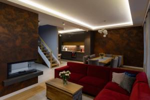 a living room with a red couch and a table at KAJKl 15 in Lidzbark Warmiński