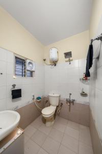 a bathroom with a toilet and a sink at Vintage Haven Leafy Getaway Luxury Villa in Indiranagar by Spacez in Bangalore