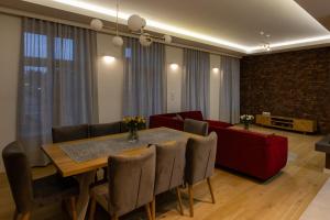 a dining room with a table and a couch at KAJKl 15 in Lidzbark Warmiński