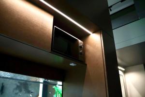 a television on the side of a building with a window at Bohemia Jacuzzi & Sauna Apartment in Klaipėda