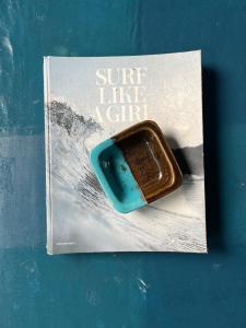 a book with a cookie on the cover of a surf like a city at The Artist House in Burgos