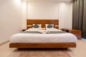 a bedroom with a large bed with towels on it at The Namami Tapovan in Rishīkesh