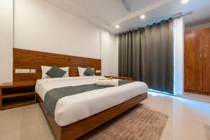a bedroom with a large bed and a large window at The Namami Tapovan in Rishīkesh