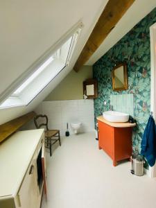 a bathroom with a sink and a toilet at Au Petit Paradis in Saint-Domet +29 photos