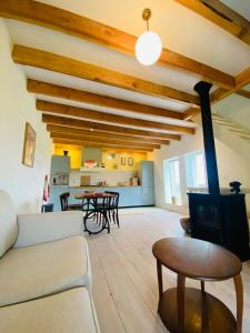a living room with a couch and a table at Au Petit Paradis in Saint-Domet
