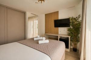 a bedroom with a bed with towels on it at Magnolia in Alicante +138 photos