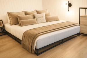 a large bed with pillows on it in a bedroom at Ma Montagne Chic 4 in La Bresse +9 photos