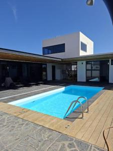 a large swimming pool in front of a house at Chalet Los Molinos in La Oliva