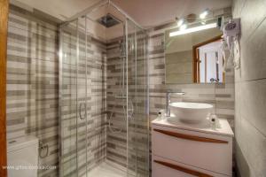 a bathroom with a shower and a sink and a mirror at U san larenzu in Aullène +35 photos