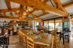a dining room with a large wooden table and chairs at U san larenzu in Aullène