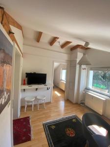 a living room with a couch and a television at Klosterherberge Economy in Meßkirch
