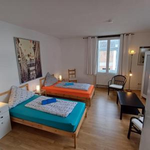 a living room with two beds and a table at Apartment Mammut Loft in Balve
