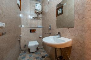a bathroom with a sink and a toilet at The Namami Tapovan in Rishīkesh +18 photos
