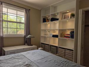 a bedroom with a large bed and a window at St Andrews Guest Home in St. John's