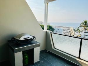 a room with a balcony with a view of the ocean at Hyde Park in Durban