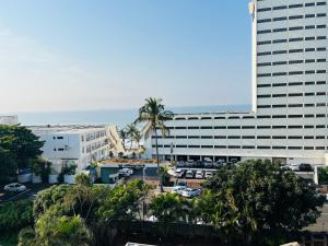 a large building with a parking lot in front of it at Hyde Park in Durban
