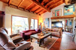 a living room with couches and a coffee table at Casa penisula in Porto-Vecchio