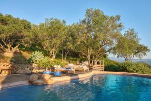 a swimming pool with trees in the background at Casa penisula in Porto-Vecchio