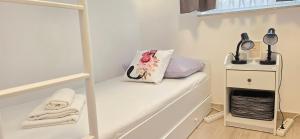 a white room with a shelf with a bag on it at Guest House Jasna in Novalja