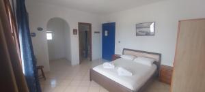 a bedroom with a bed with two pillows on it at Castello Azzurro in Agia Anna Naxos