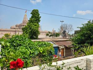 a view of a building with a red flower at Royal Rani Residency in Ayodhya