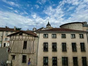 an old building in front of a building with a tower at Studios Citadelle in Parthenay