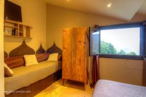 a bedroom with a wooden bed and a window at Couvent d'alando in Alando +49 photos