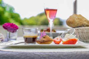 a plate of food with a drink and fruit on a table at Couvent d'alando in Alando