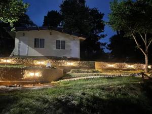 an old building with lights in front of it at night at The Cottage Depot in Bīr