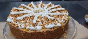 a chocolate cake with white frosting on a glass plate at "Nesthocker" Café-Snackbar-Pension-Bauwagencamp in Offingen +15 photos